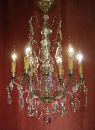 typical french chandelier with delicate arms and lots of crystal nickel silver color